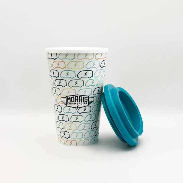 The Morris Commercial Pink Travel Cup. The eco-friendly travel cup for hot drinks is decorated with the Morris JE Electric Van. 