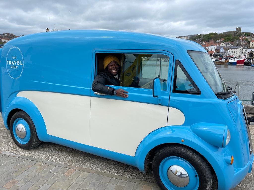 Ade Adepitan driving the Morris JE1 as part of filming for the BBC The Travel Show