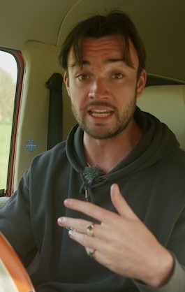 Jack Scarlett talking to the camera while driving the Morris JE
